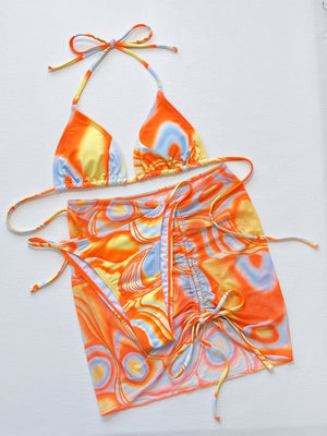 Multicolor swirl print string bikini set with a matching mesh sarong.