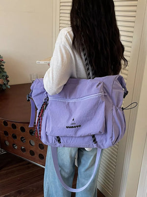 Lavender Oxford cloth travel duffel bag with embroidered logo and multiple pockets.