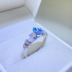 Silver ring with blue oval moissanite and mother-of-pearl accents
