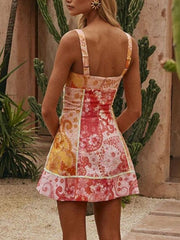 Floral mini dress with sweetheart neckline and patchwork print.