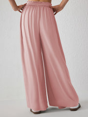 Drape-front wide-leg jersey trousers in watermelon pink with smocked waistband.