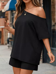 Black asymmetrical one-shoulder top with shorts set, featuring pockets.