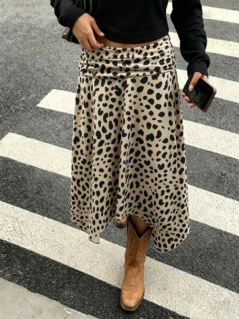 Leopard print midi skirt with asymmetrical hem and ruched waist detail.