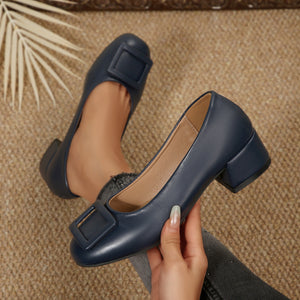 Dark blue leather block heel shoes with square buckle detail.
