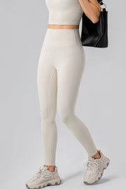 Ivory high-waist performance leggings with contour stitching and a smooth finish.