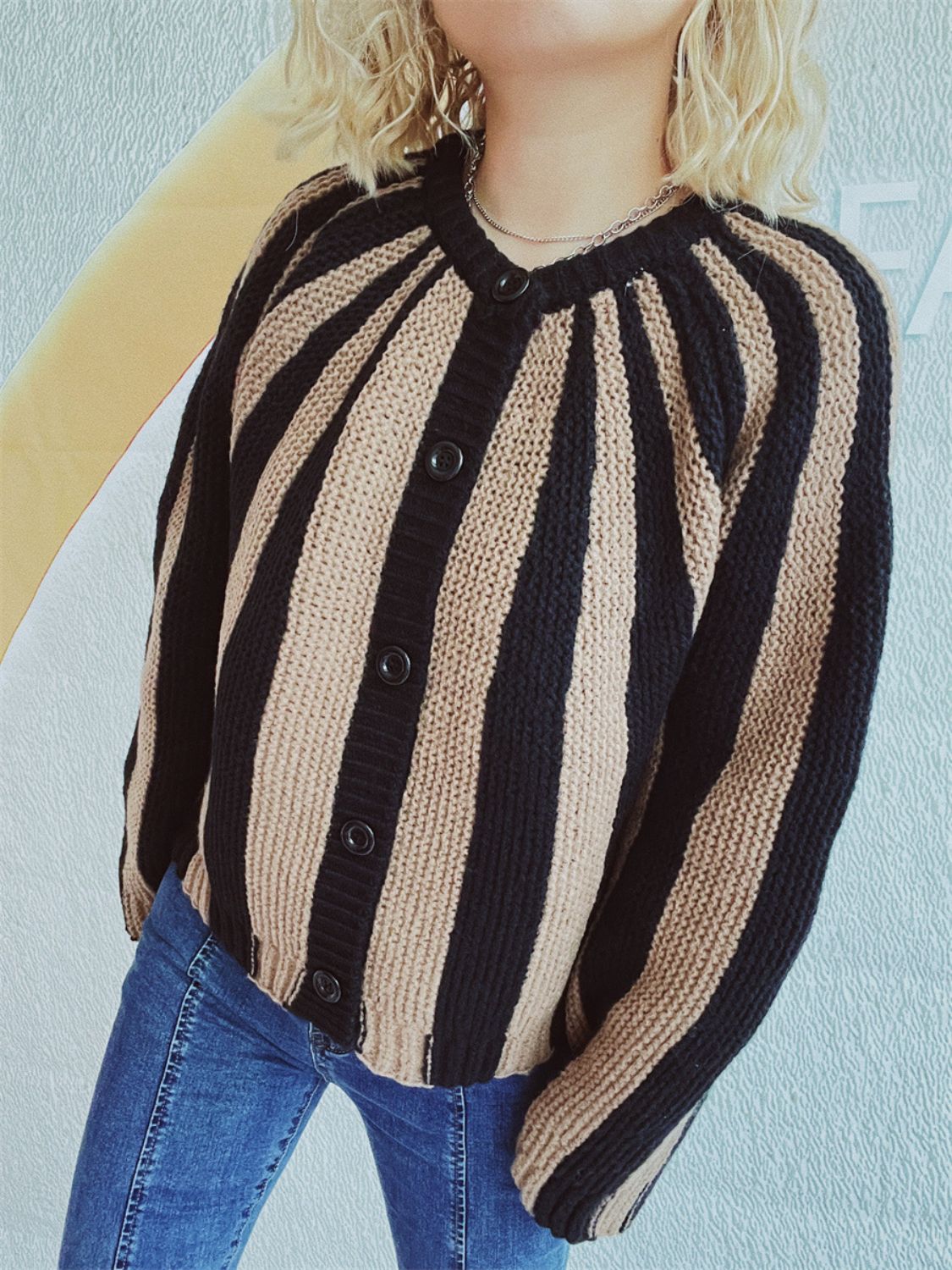 Bold stripe knit cardigan in tan and black with button front and crew neck.