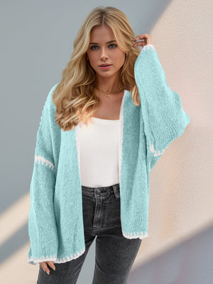 Oversized knit cardigan in Tiffany Blue with white contrast stitching on edges and sleeves.