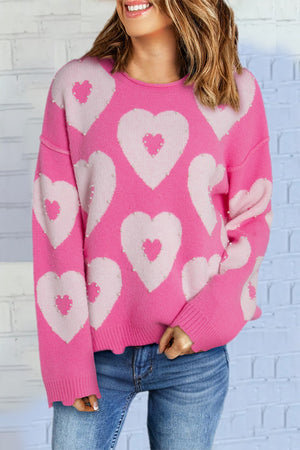 Fuchsia pink knit sweater with allover pearl-embellished heart motif and crew neck.