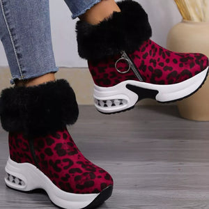 Plush leopard print ankle boots with side zipper and black fur trim.