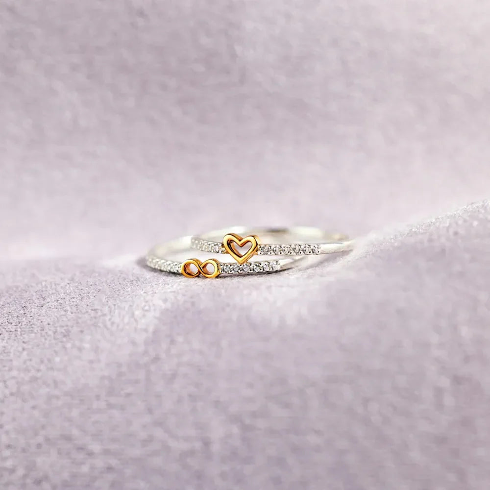 Silver rings with heart and infinity charms, accented with small crystals