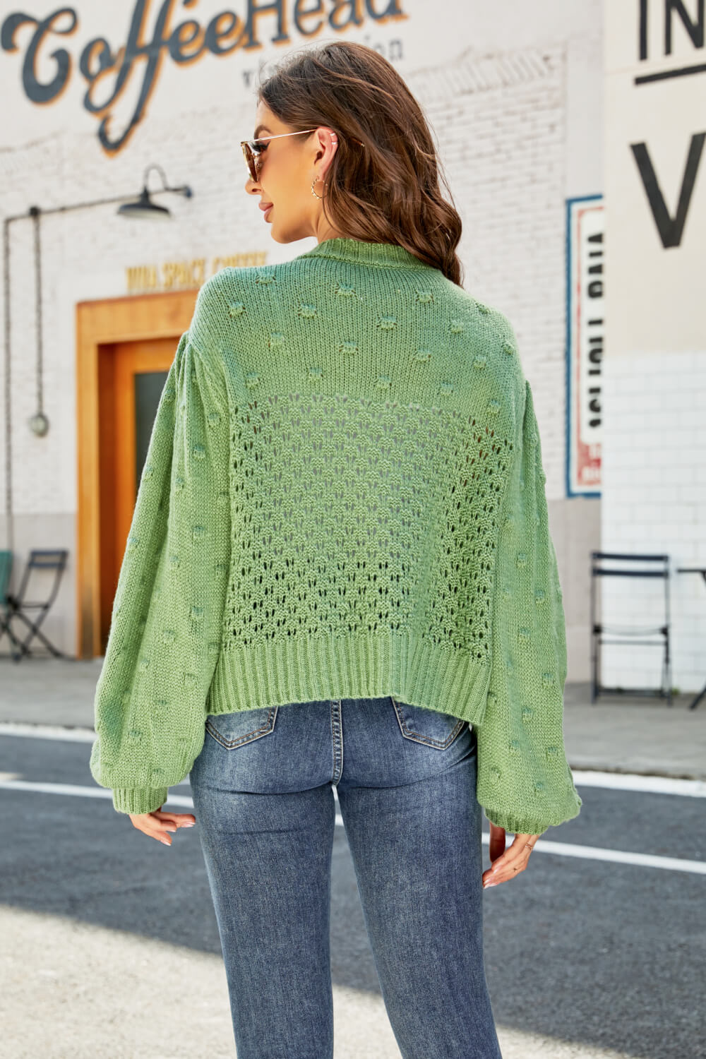 Green bubble sleeve cropped cardigan with textured detail and open knit pattern.