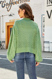 Green bubble sleeve cropped cardigan with textured detail and open knit pattern.