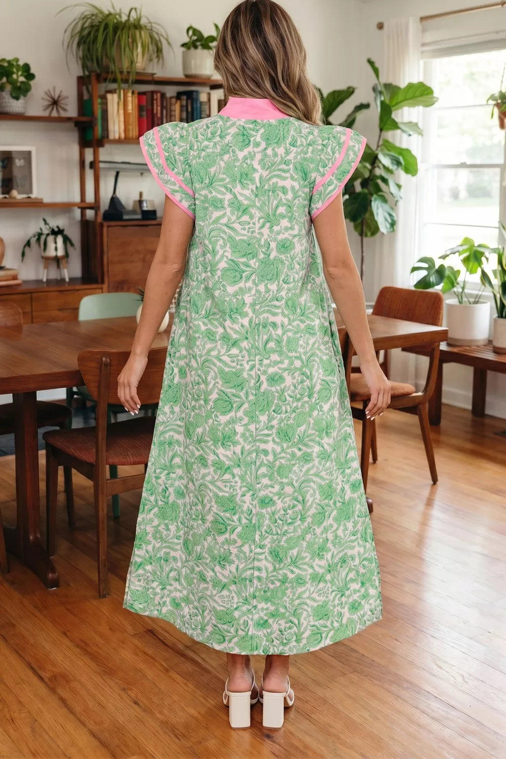 Botanical print midi dress with flutter sleeves, pink trim, and collar.