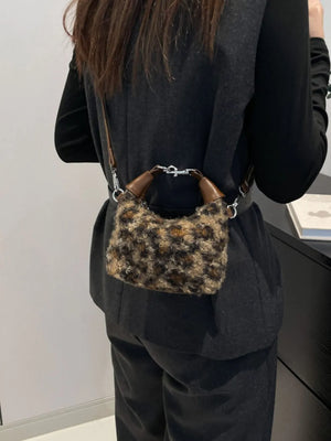 Shearling check mini shoulder bag with brown leather handles and silver hardware.