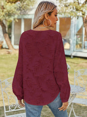 Burgundy textured puff sleeve blouse with V-neck, shown from the back.