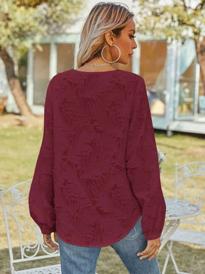 Burgundy textured puff sleeve blouse with V-neck, shown from the back.