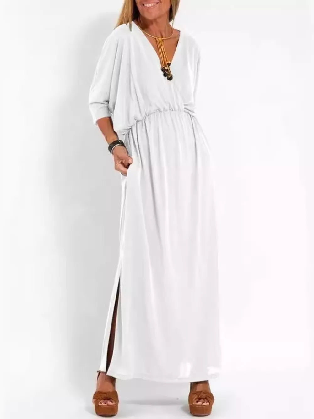 White V-neck maxi dress with dolman sleeves, cinched waist, and high side slits.