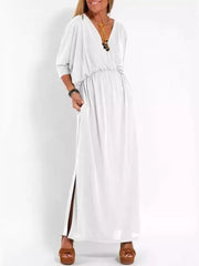 White V-neck maxi dress with dolman sleeves, cinched waist, and high side slits.
