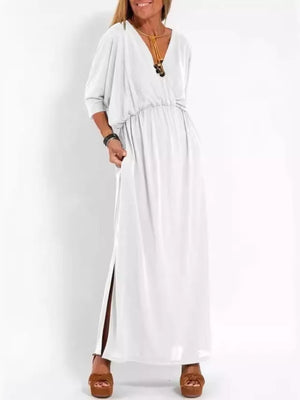 White V-neck maxi dress with dolman sleeves, cinched waist, and high side slits.