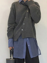 Dark Gray asymmetric button-up knit cardigan with silver buttons, worn over a blue collared shirt.