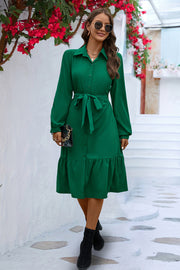 Green shirt dress with tie waist and ruffled hem, long sleeves, collared neckline.