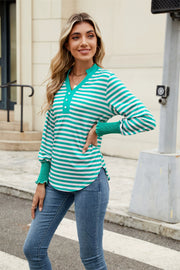 Striped long sleeve blouse in turquoise and white with buttoned neckline and smocked cuffs.