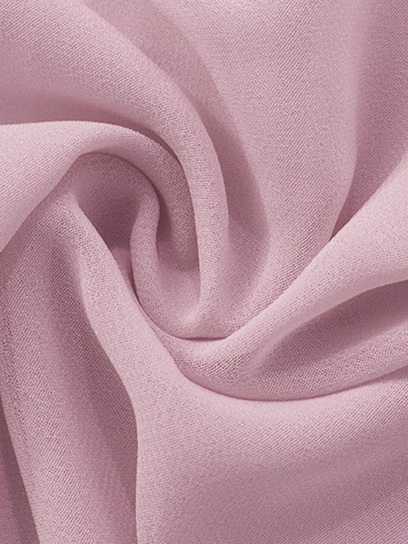 Sheer chiffon mini dress fabric in a soft pink, showing draped texture.