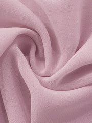 Sheer chiffon mini dress fabric in a soft pink, showing draped texture.