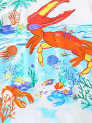 White cotton crew neck t-shirt with colorful underwater scene featuring crabs, jellyfish, fish, and coral.