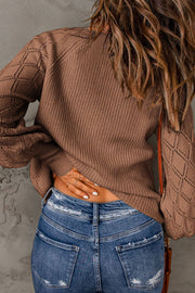 Diamond-cut sleeve knit cardigan in taupe with ribbed texture.