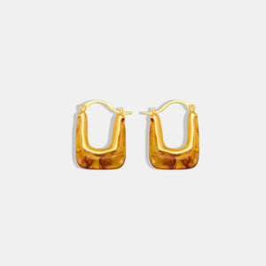 Amber resin geometric hoop earrings in gold with a marbled pattern.