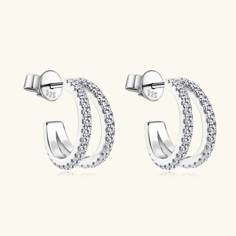 Silver double-band hoop earrings with moissanite stones and 925 stamp.