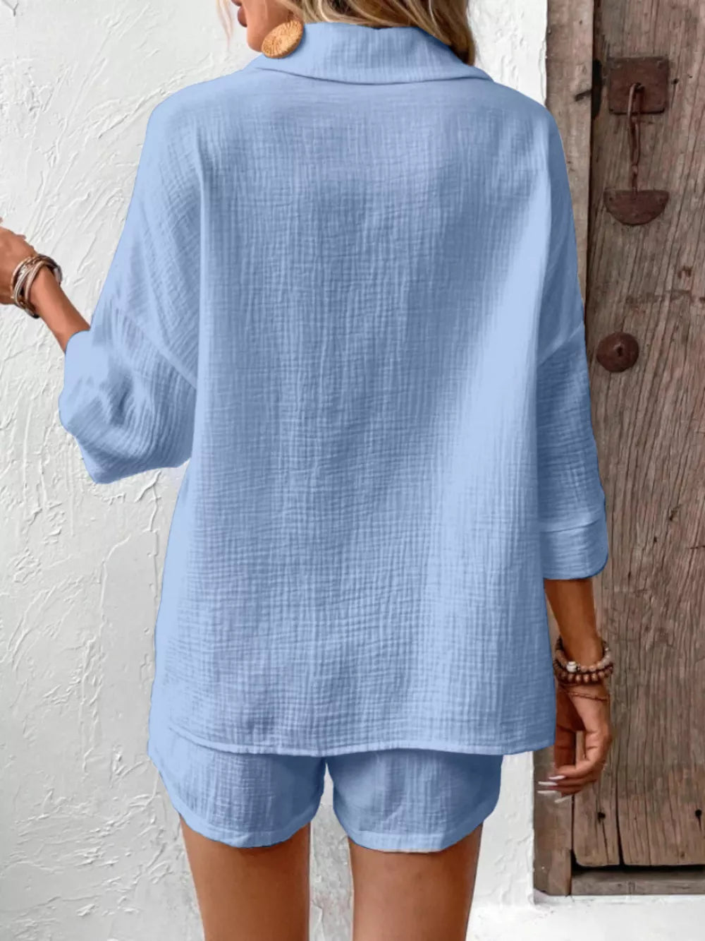 Sky blue cotton two-piece set with textured fabric and button detail.