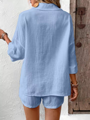 Sky blue cotton two-piece set with textured fabric and button detail.