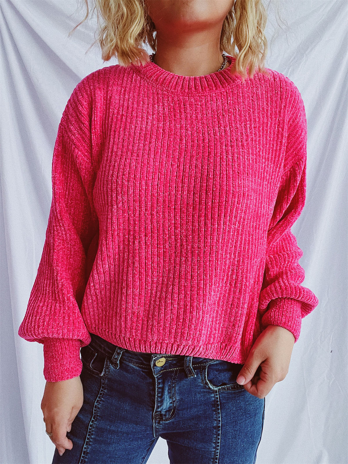 Textured ribbed knit crewneck pullover sweater in bright pink with balloon sleeves.