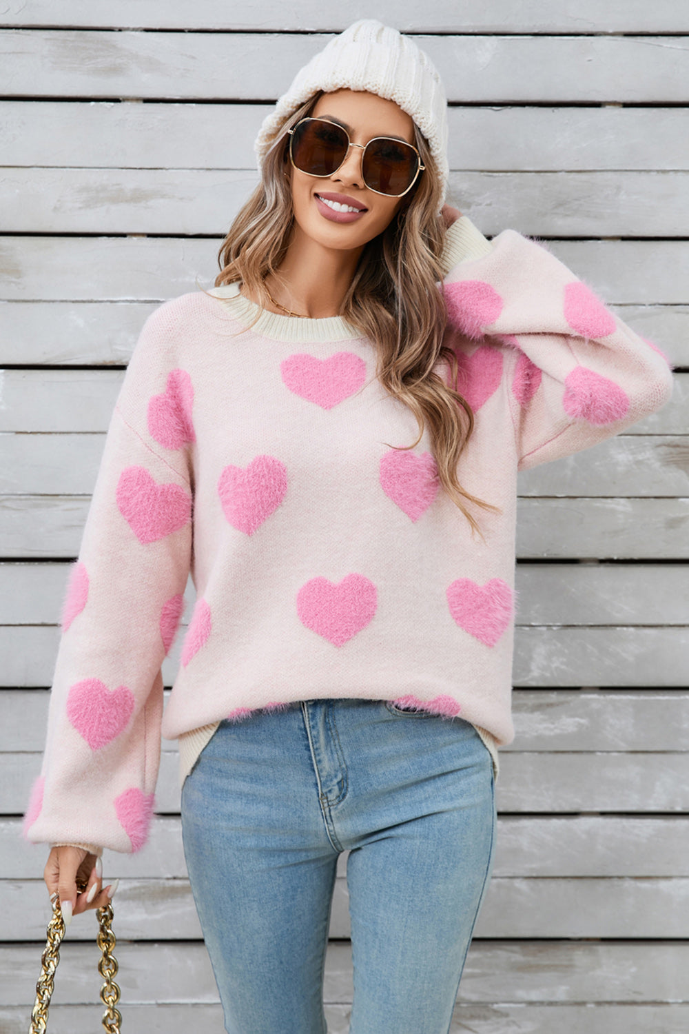 Blush pink fluffy knit sweater with allover pink hearts, crew neck, and long sleeves.