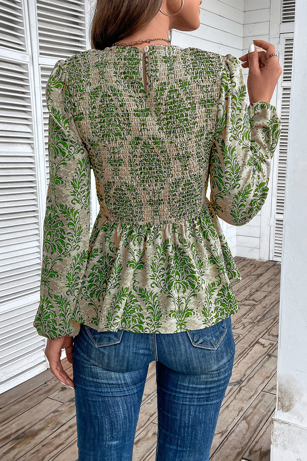 Green damask print peplum blouse with smocking and puff sleeves.