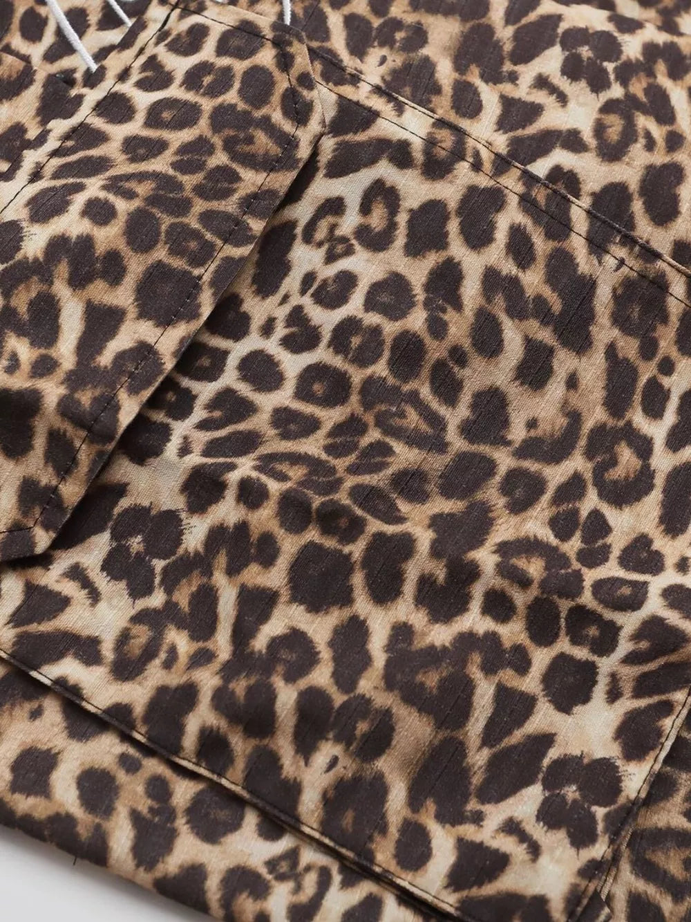 Men's leopard print cargo sweatpants with visible pocket details.