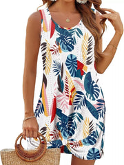Eyelet tank dress with multicolor tropical leaf print and twisted hem detail.
