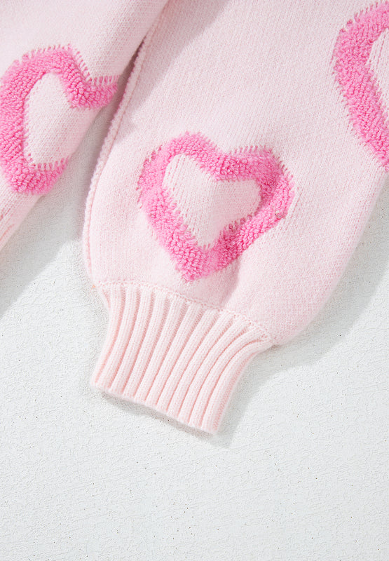 Pink knit sweater with fuzzy heart appliques and balloon sleeves.