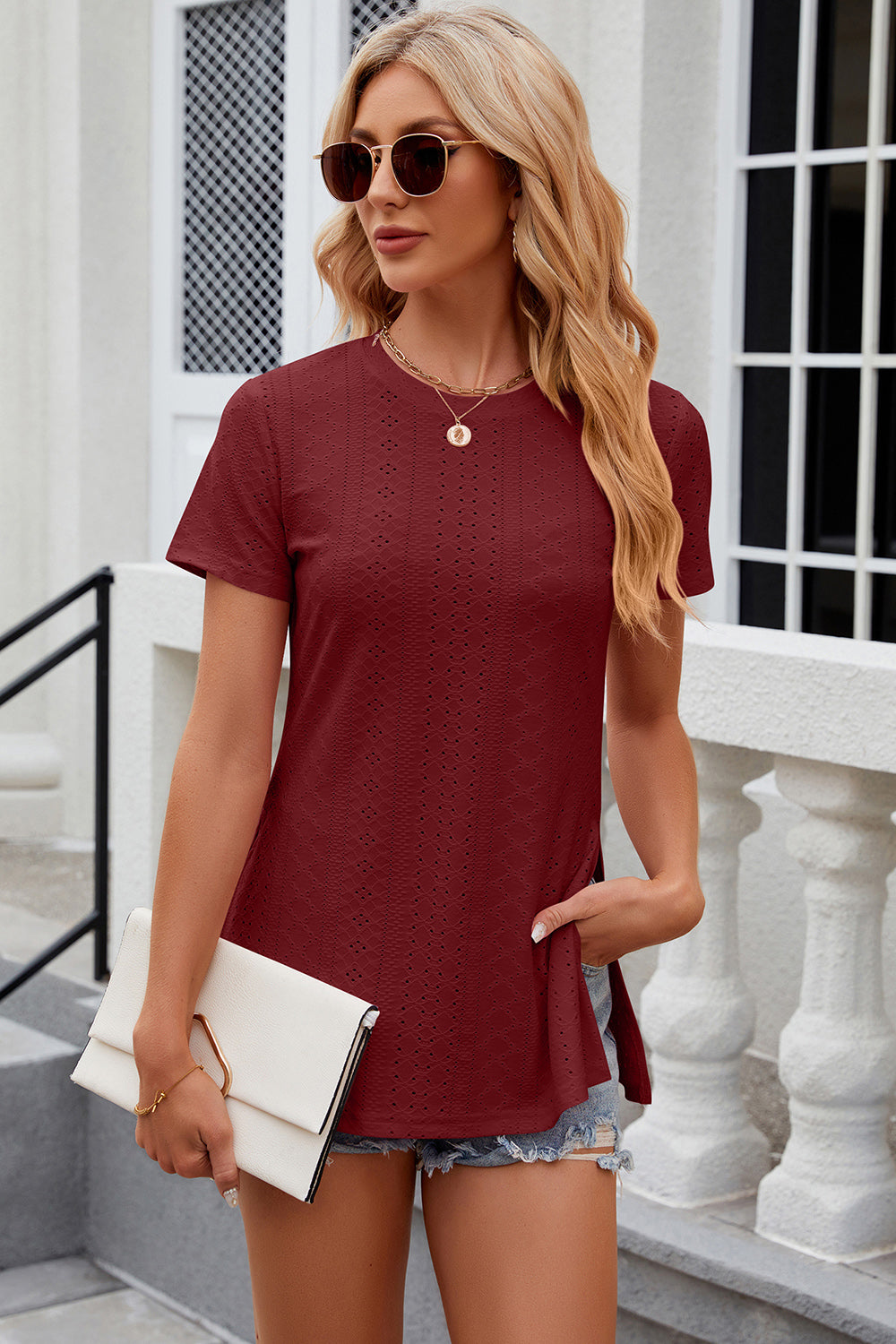 Burgundy crewneck top with perforated detail and side slits, short sleeves