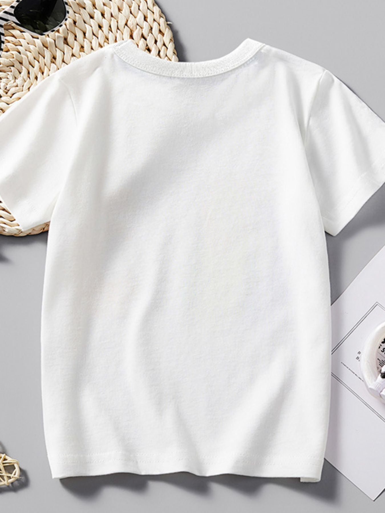 White cotton crew neck short sleeve toddler t-shirt with excavator graphic detail.