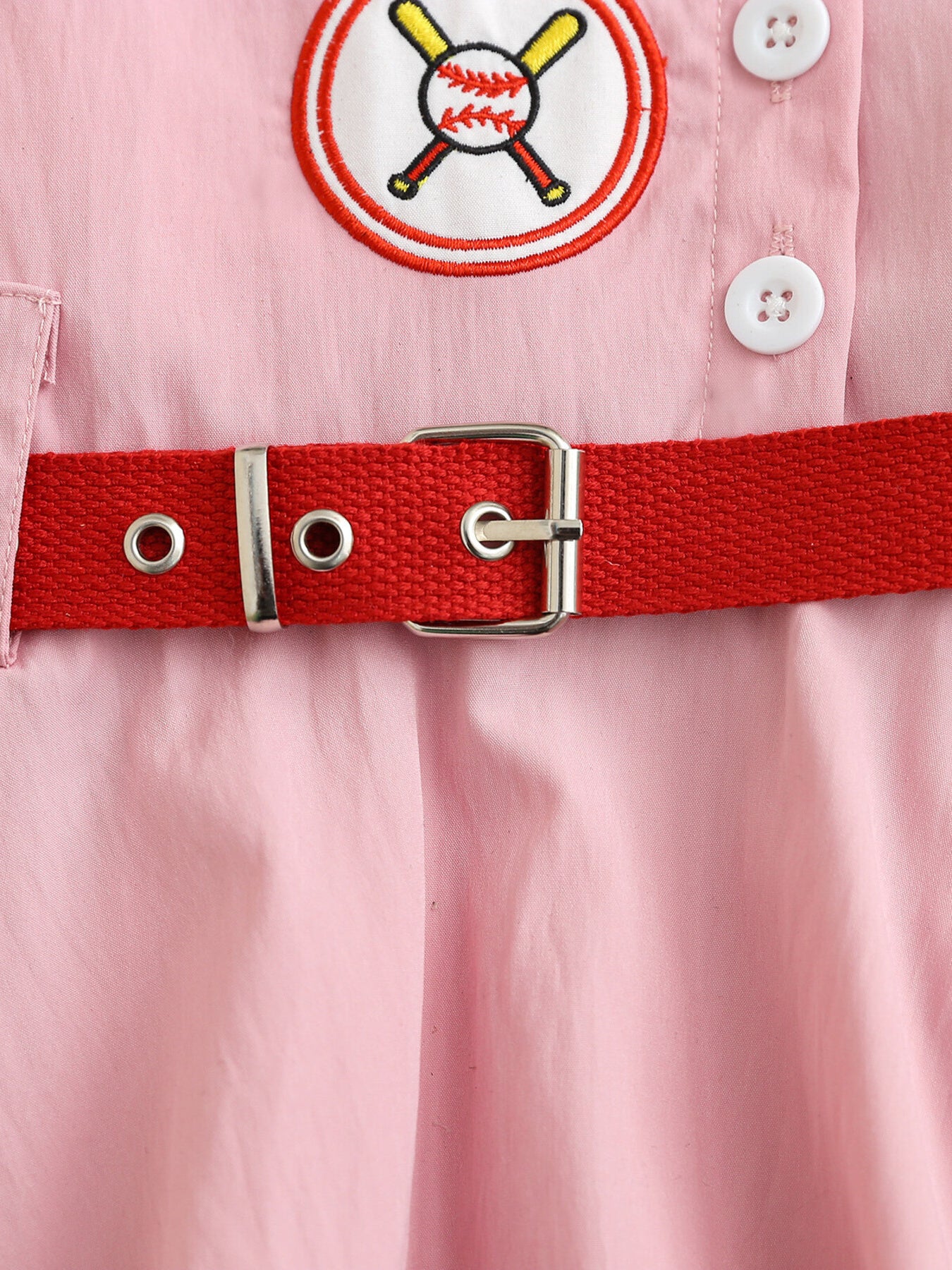 Pink cotton blend baseball dress for kids with embroidered patch and red adjustable belt.