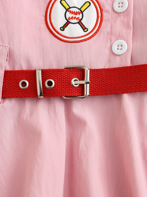 Pink cotton blend baseball dress for kids with embroidered patch and red adjustable belt.