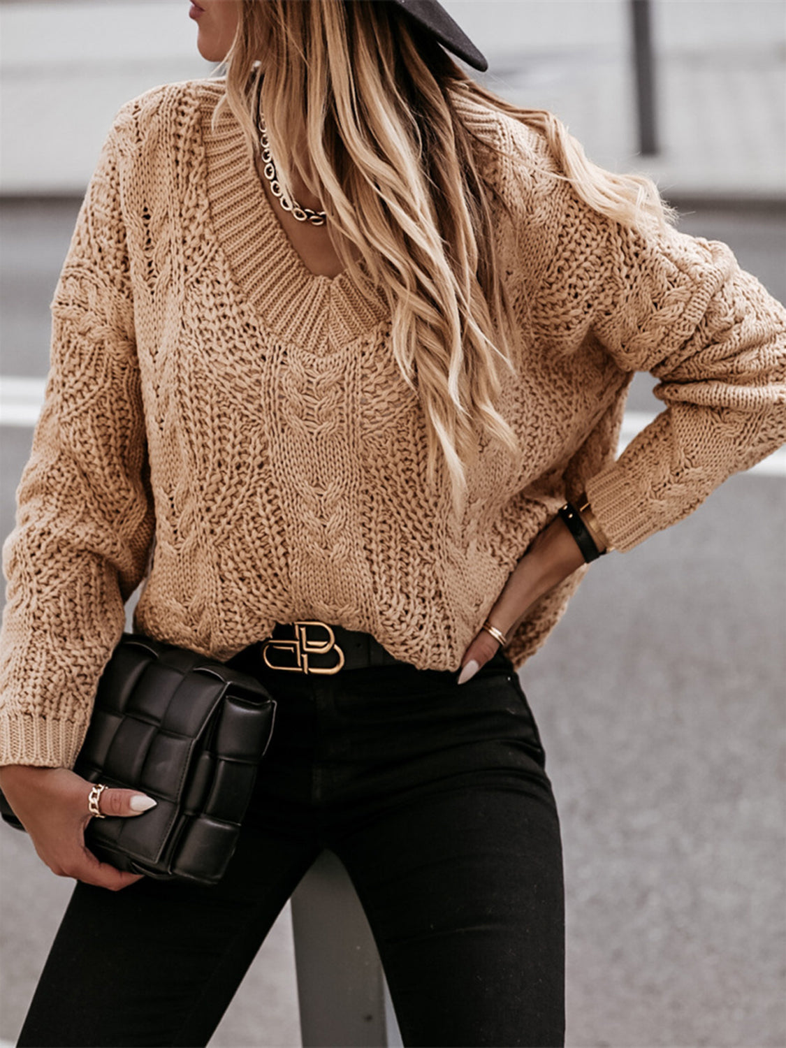 Khaki cable knit v-neck sweater with relaxed fit and textured pattern.
