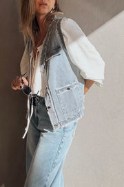 Light wash denim vest with frayed edges and chest pockets, button-down front.