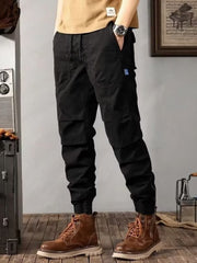 Men's black cargo jogger pants with drawstring waist and elastic cuffs.