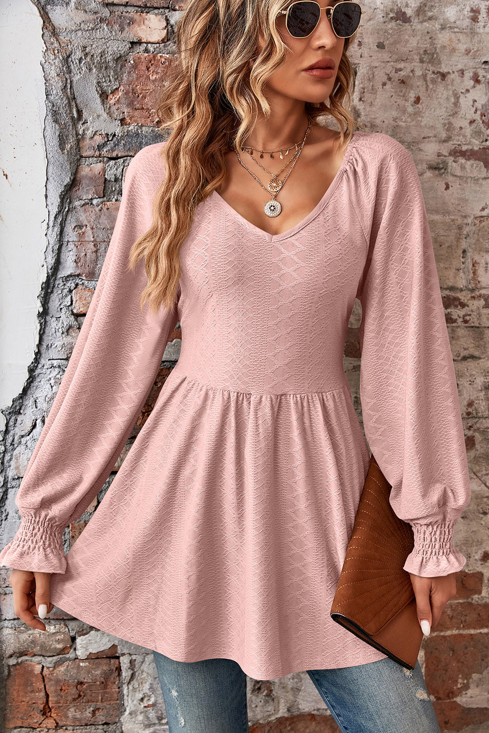 Blush pink textured empire waist blouse with shirred sleeves and V-neck