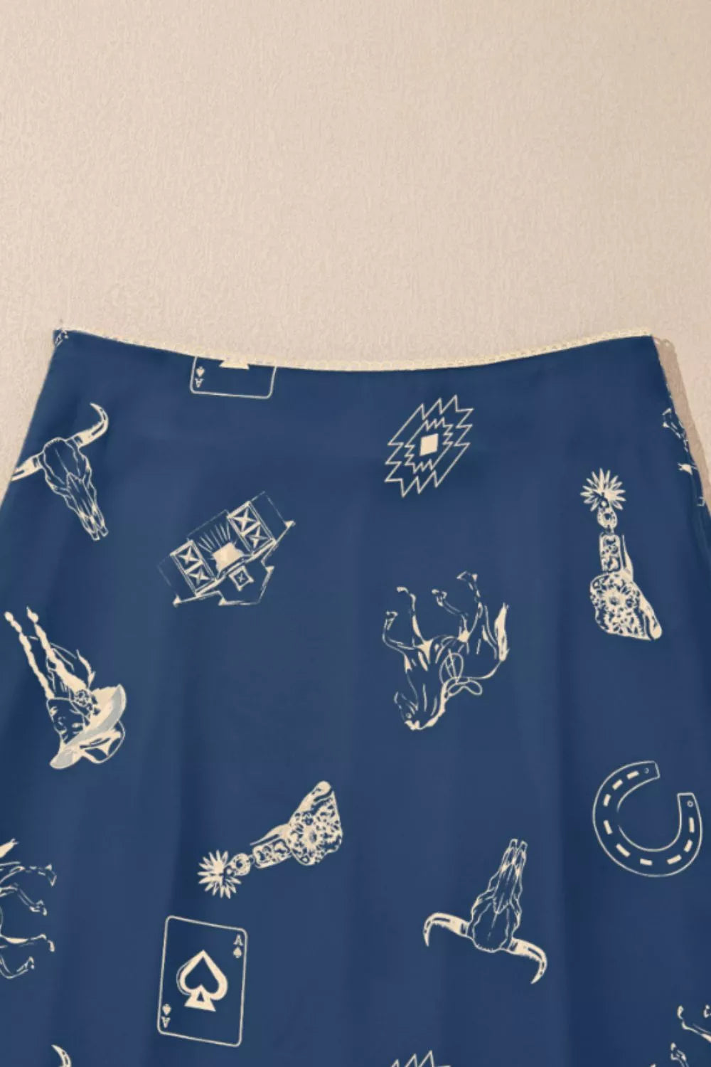 Blue satin maxi skirt with western print and draping.