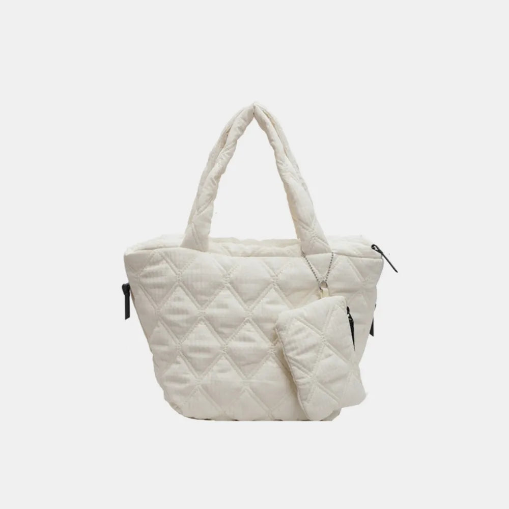 Quilted ivory shopper tote bag with matching pouch and silver charm detail.
